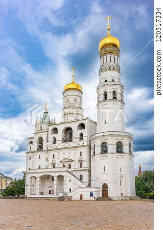 Ivan the Great Bell Tower, with Assumption Belfry on the right in Moscow Kremlin. Blue sky background with sunbeams 120517334