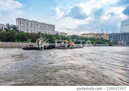 A barge with a tugboat floats along the Moscow River A barge with a tugboat floats along the Moscow River 120517357