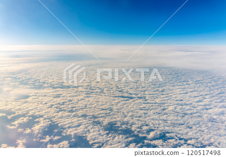 View from the airplane window at a beautiful cloudy sky and the airplane wing 120517498