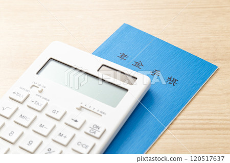 Calculator and pension book on a table Calculator and pension book on a table 120517637
