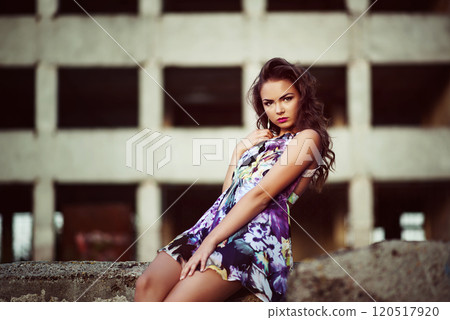 Portrait of a beautiful model posing in evening light measure concrete wall Portrait of a beautiful model posing in evening light measure concrete wall 120517920