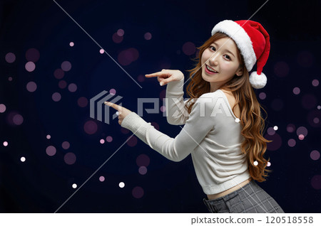Young woman wearing a Christmas costume pointing 120518558