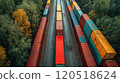 Colorful shipping containers align along a narrow road surrounded by lush green and golden trees in 120518624