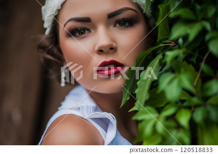 Beautiful tanned girl with natural make-up and wet hair among exotic plants. Beautiful tanned girl with natural make-up and wet hair among exotic plants. 120518833