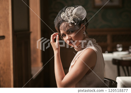 Beautiful girl sitting at a table at the Restaurant 120518877