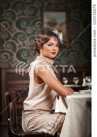 Beautiful girl sitting at a table at the Restaurant 120518878