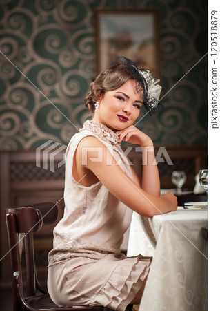 Beautiful girl sitting at a table at the Restaurant 120518879
