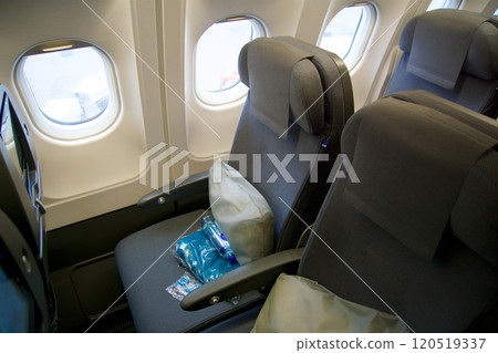 STOCKHOLM, SWEDEN - NOVEMBER 24, 2018: Economy Class aircraft seat in a long-haul cabin on the way to the USA STOCKHOLM, SWEDEN - NOVEMBER 24, 2018: Economy Class aircraft seat in a long-haul cabin on the way to the USA 120519337