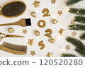 Banner with golden hairdressing tools numbers 2025 comb with fir twigs on white background. Horizontal winter holiday flatlay with hair salon accessories, Christmas balls stars. 120520280