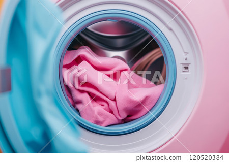 Colorful clothes in a washing machine drum Colorful clothes in a washing machine drum 120520384