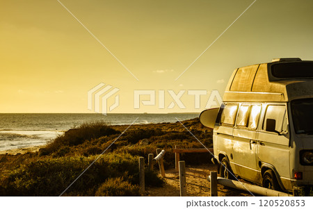 Camper van with surf board on beach 120520853