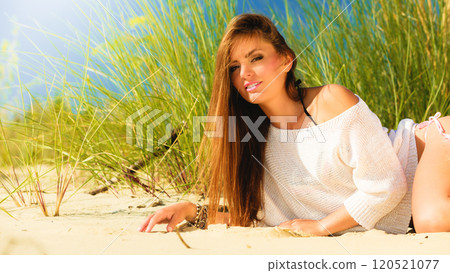 Young woman posing on grassy dune 120521077
