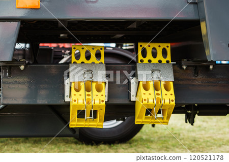 Yellow brake stop blocks wedges on red tractor 120521178