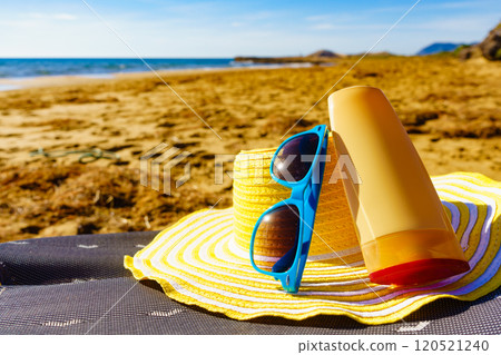 Sun protection gear on sand beach Sun protection gear on sand beach 120521240