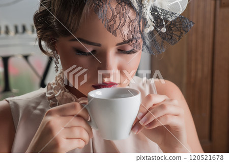 Beautiful sensual woman with long dark hair in luxurious sequin dress posing in summer  cafe. 120521678