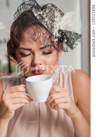 Beautiful sensual woman with long dark hair in luxurious sequin dress posing in summer cafe. Beautiful sensual woman with long dark hair in luxurious sequin dress posing in summer cafe. 120521696