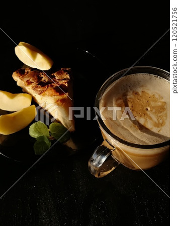 Сup of coffee tea on the table with a homemade cake decorated with a fresh mint Сup of coffee tea on the table with a homemade cake decorated with a fresh mint 120521756