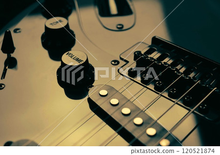 Abstract photo of an electric guitar and its parts macro photo. Music wallpaper and banner for string music album. High quality photo guitar in dark with light reflected in the lacquered surface.  120521874