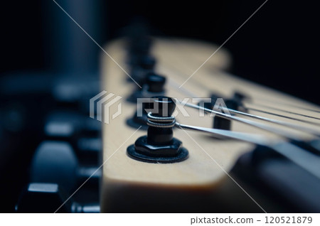 Abstract photo of an electric guitar and its parts macro photo. Music wallpaper and banner for string music album. High quality photo guitar in dark with light reflected in the lacquered surface.  120521879