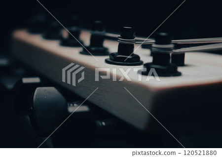 Abstract photo of an electric guitar and its parts macro photo. Music wallpaper and banner for string music album. High quality photo guitar in dark with light reflected in the lacquered surface.  Abstract photo of an electric guitar and its parts macro photo. Music wallpaper and banner for string music album. High quality photo guitar in dark with light reflected in the lacquered surface.  120521880
