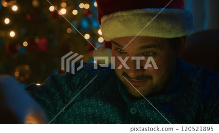 Young Man Amazed By The Magic Of Christmas At Night At Home Near The Tree 120521895