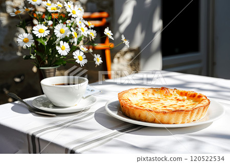 Cup of tea and delicious French pie with smoked brisket and Quiche Lorraine cheese on a table with a white tablecloth, tart for breakfast in a French cafe, vacation in popular places Cup of tea and delicious French pie with smoked brisket and Quiche Lorraine cheese on a table with a white tablecloth, tart for breakfast in a French cafe, vacation in popular places 120522534