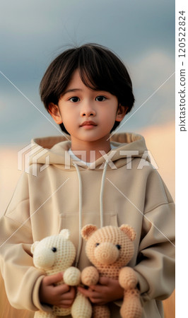A girl in a sweatshirt holds funny toy African animals in her hands, the toys are made in the Japanese amigurumi style, vertical portrait A girl in a sweatshirt holds funny toy African animals in her hands, the toys are made in the Japanese amigurumi style, vertical portrait 120522824