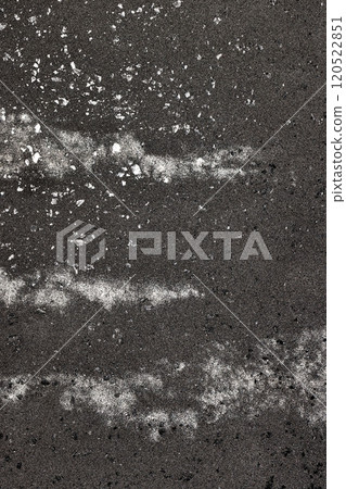 Elegant patterns of white sand on dark volcanic shore create a striking visual contrast 120522851