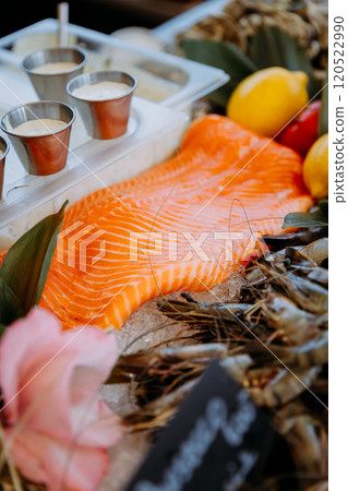 Fresh salmon fillet on ice with seafood and sauces, gourmet dining and culinary photography Fresh salmon fillet on ice with seafood and sauces, gourmet dining and culinary photography 120522990