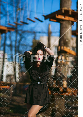 A beautiful young girl posing outdoors.Beautiful woman with a magnificent black hair. 120523027