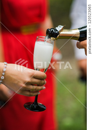 A glass of champagne poured A glass of champagne poured 120523065