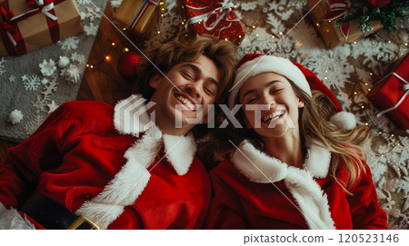 Laughing Couple On Their Backs Wearing Matching Holiday Pajamas Surrounded By Christmas Gifts. Generative AI. 120523146