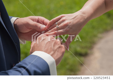 Couple holding hands outdoors feeling.hands close up of a couple in love 120523451