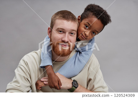 Portrait shot of adorable little Black boy holding hands with happy adoptive father 120524309