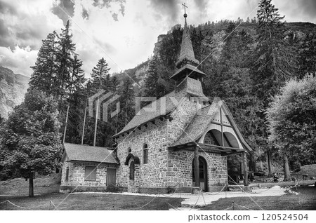 Chapel standing on Lake Braies in the Italian Dolomites 120524504