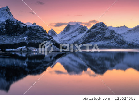 Colorful sunset sky over snowy mountains reflecting in water Colorful sunset sky over snowy mountains reflecting in water 120524593