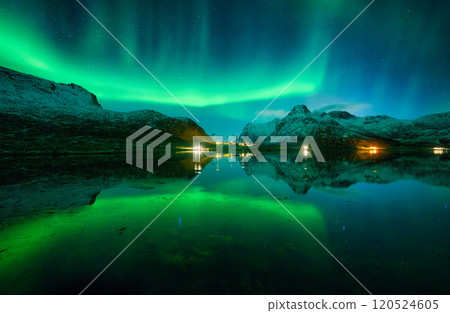 Aurora borealis and night starry sky reflected in lake in winter 120524605