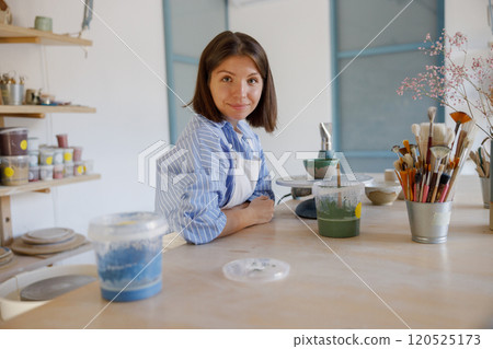 A Creative Artist Engaged in Crafting Masterpieces Within a Bright Studio Environment 120525173