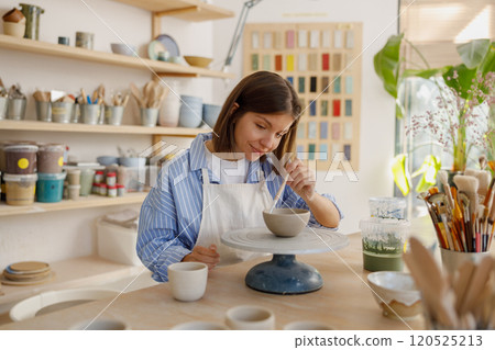 A talented Pottery Artist is passionately Creating oneofakind Unique Ceramics in Their Studio 120525213