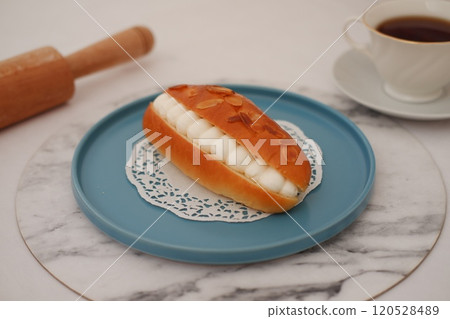 Eclair on a blue plate Eclair on a blue plate 120528489