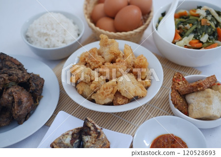 traditional Indonesian food arranged neatly on a white surface 120528693