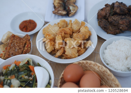 traditional Indonesian food arranged neatly on a white surface 120528694