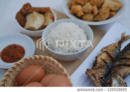 traditional Indonesian food arranged neatly on a white surface 120528695