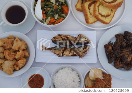 traditional Indonesian food arranged neatly on a white surface 120528699