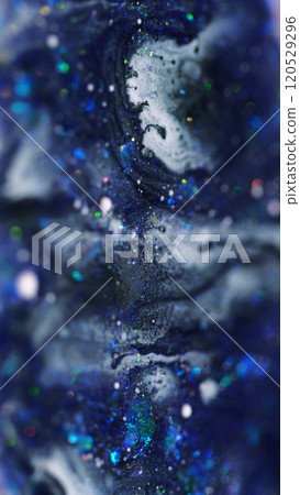 Shimmering flow. Ink wave. Defocused blue purple black color shiny sequin glitter particles paint emulsion liquid spill dark abstract art background with bokeh lights. Shimmering flow. Ink wave. Defocused blue purple black color shiny sequin glitter particles paint emulsion liquid spill dark abstract art background with bokeh lights. 120529296