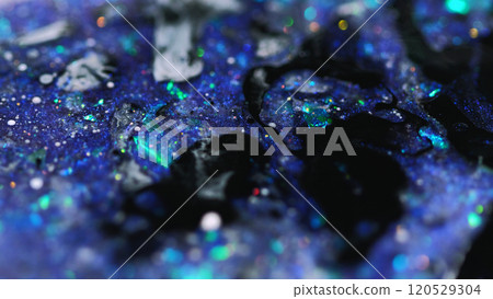 Sparkling fluid. Ink splash. Defocused purple black color shiny sequin glitter particles paint emulsion liquid spill abstract art background with bokeh lights. Sparkling fluid. Ink splash. Defocused purple black color shiny sequin glitter particles paint emulsion liquid spill abstract art background with bokeh lights. 120529304