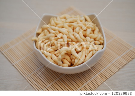 telur gabus sticks in a bowl on wooden table telur gabus sticks in a bowl on wooden table 120529958