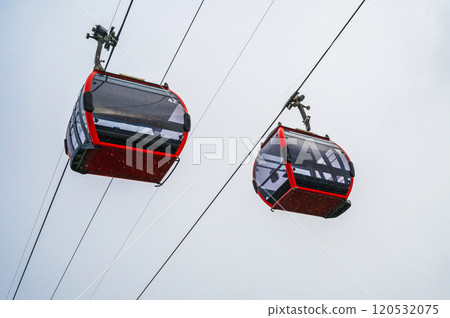 red cabins of the funicular on the cable car in mountains in the fog in the rain red cabins of the funicular on the cable car in mountains in the fog in the rain 120532075