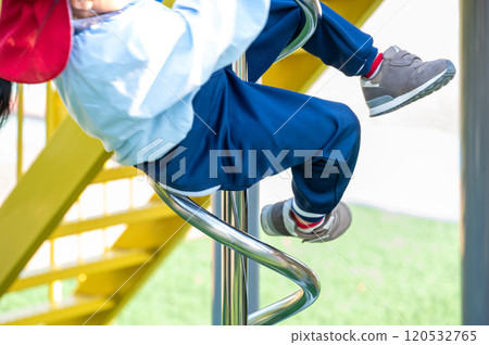 Playground equipment in the park: a spinning slide Playground equipment in the park: a spinning slide 120532765