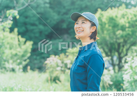 Smiling female worker standing in nature Smiling female worker standing in nature 120533456